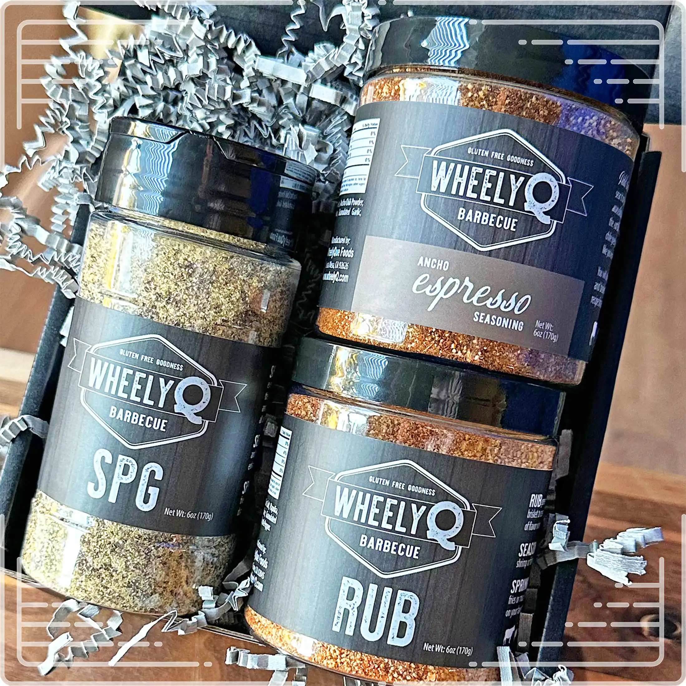 Image of our Rub and Seasoning Gift Box from WheelyQ Barbecue.  This gift set includes 1 jar of Ancho Espresso Seasoning, 1 bottle of SPG Seasoning and 1 jar of All-Purpose Rub.