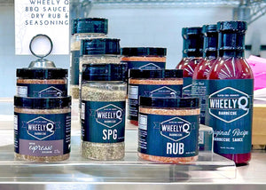 Collection of WheelyQ Barbecue products.   Original Recipe Barbecue Sauce, All-Purpose Rub, Ancho Espresso Seasoning and SPG Seasoning