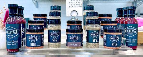 Collection of WheelyQ Barbecue products.   Original Recipe Barbecue Sauce, All-Purpose Rub, Ancho Espresso Seasoning and SPG Seasoning