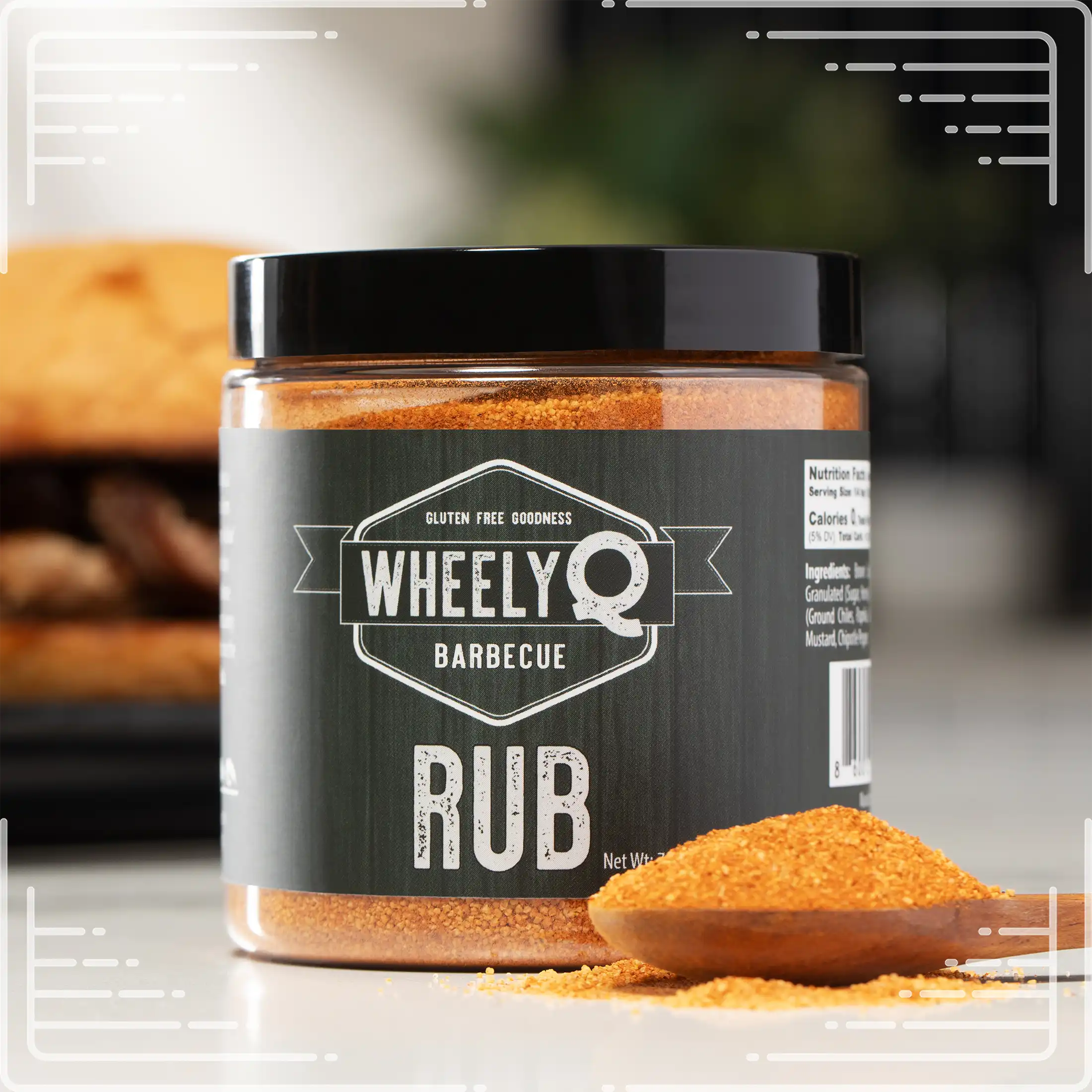 WheelyQ Barbecue All-Purpose Barbecue Rub with a spoonful of rub in a wooden spoon.