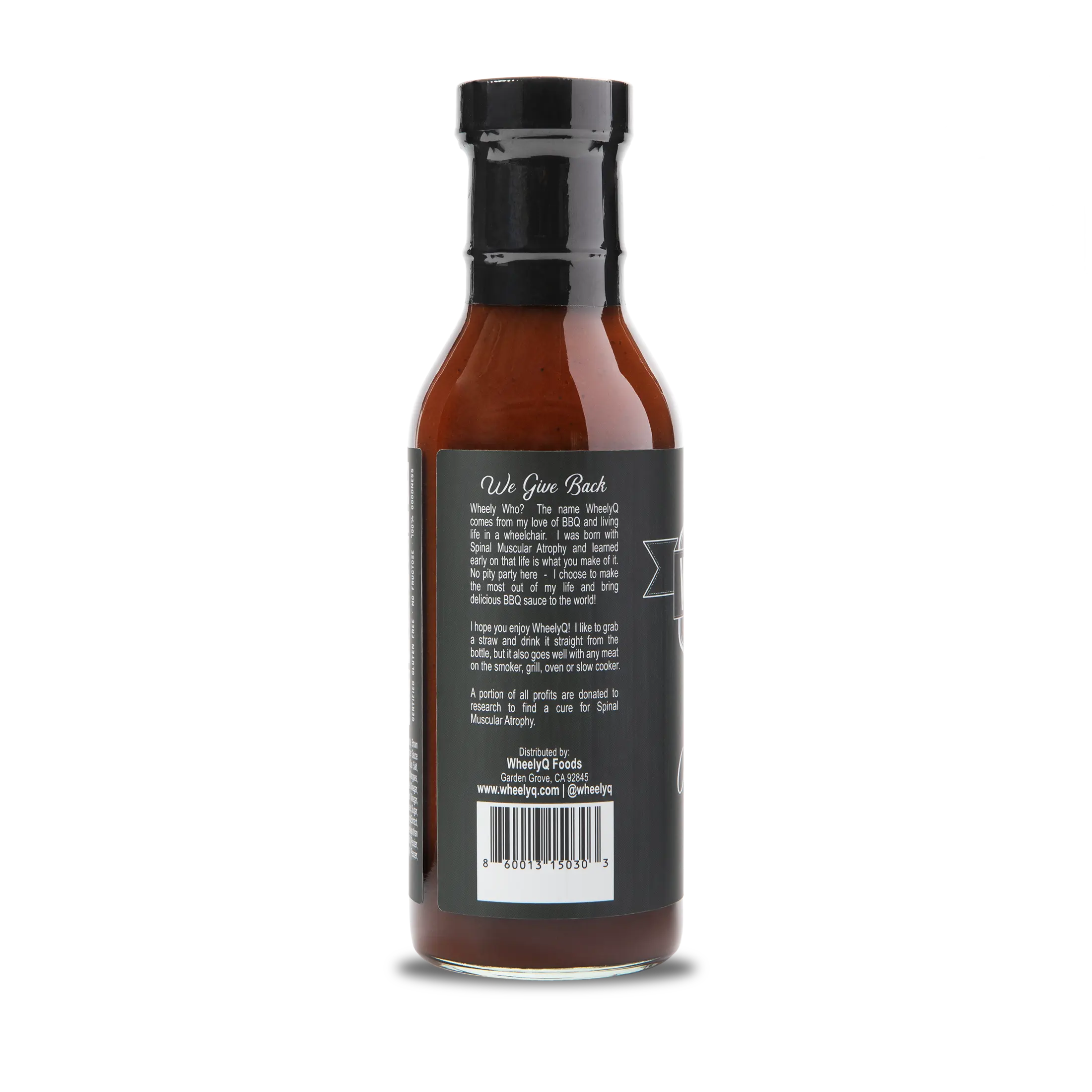 A bottle of WheelyQ Original Recipe Barbecue Sauce showing the left side of the bottle.