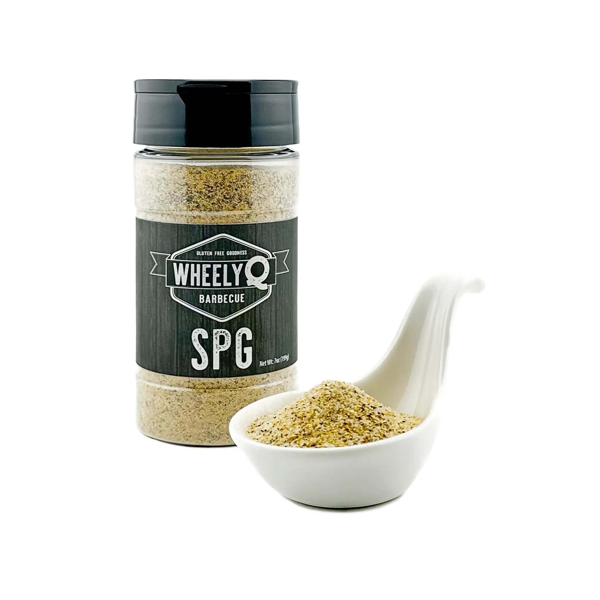 A white soup spoon filled with SPG Seasoning in the foreground and a bottle in the background.