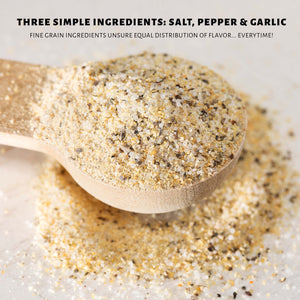 Wooden spoon filled with a mixture of salt, pepper, and garlic on a white surface. WheeyQ's SPG Seasoning uses fine grain ingredients to ensure equal distribution of flavor - everytime!