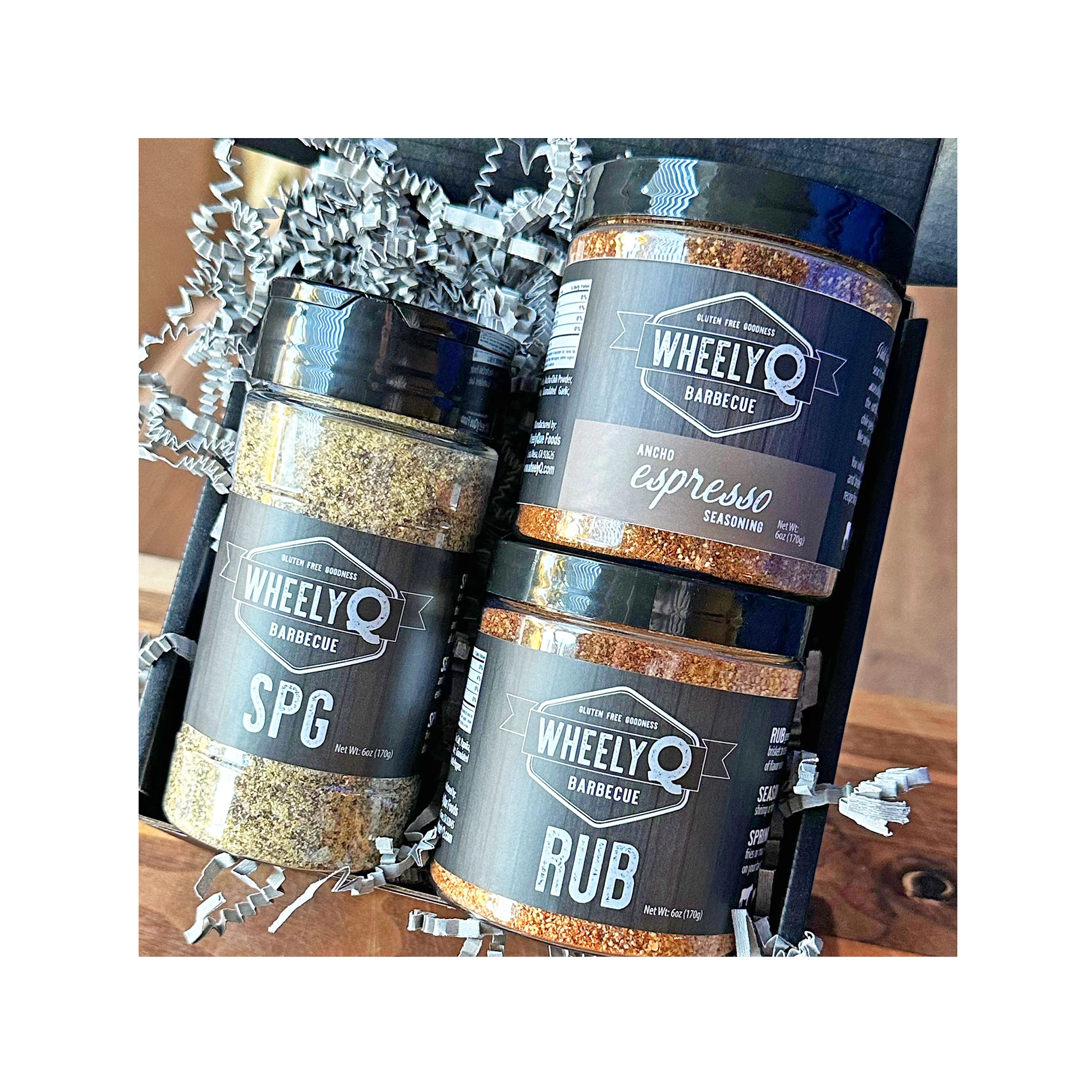 Image of our Rub and Seasoning Gift Box from WheelyQ Barbecue.  This gift set includes 1 jar of Ancho Espresso Seasoning, 1 bottle of SPG Seasoning and 1 jar of All-Purpose Rub.