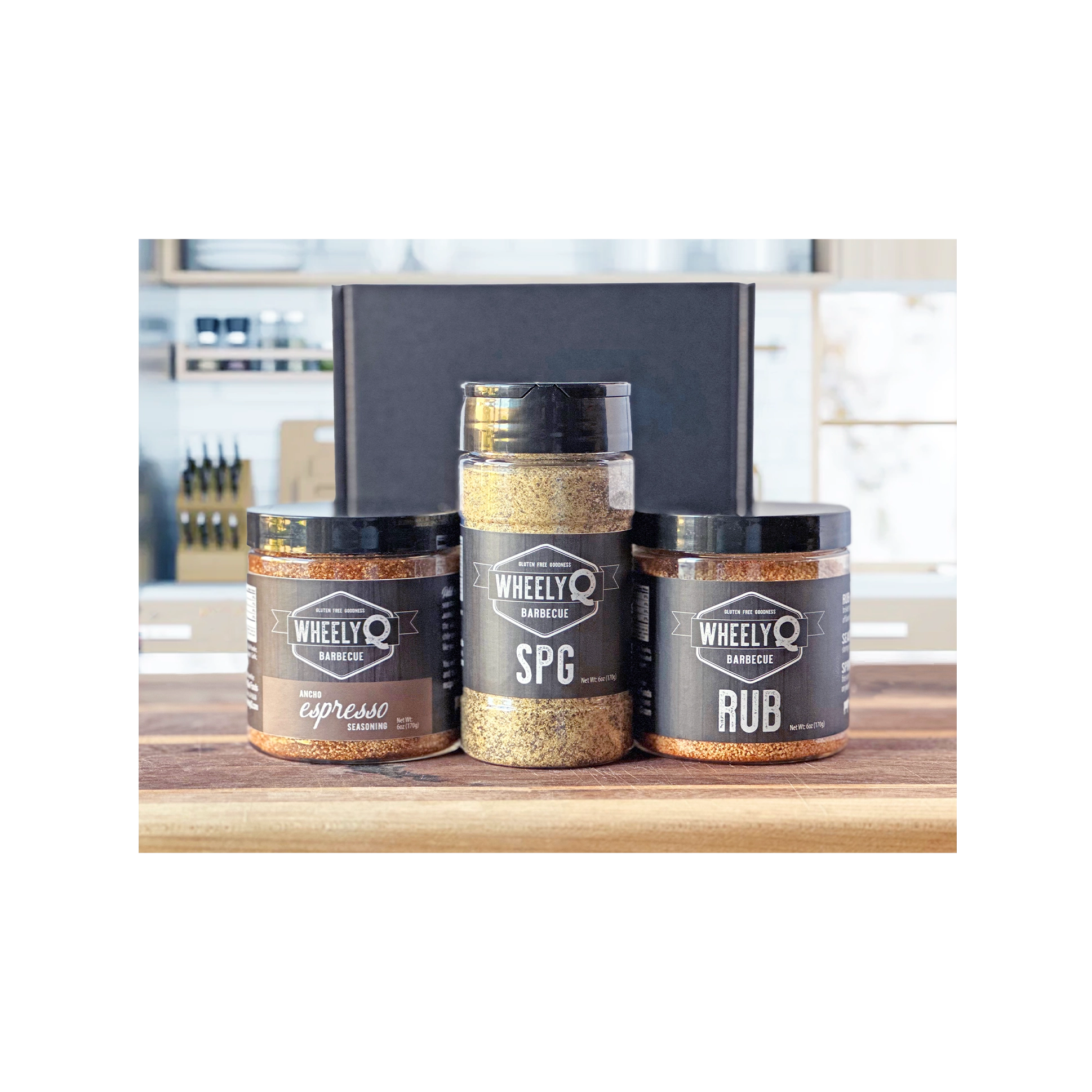 Image of our Rub and Seasoning Gift Box from WheelyQ Barbecue.  This gift set includes 1 jar of Ancho Espresso Seasoning, 1 bottle of SPG Seasoning and 1 jar of All-Purpose Rub.
